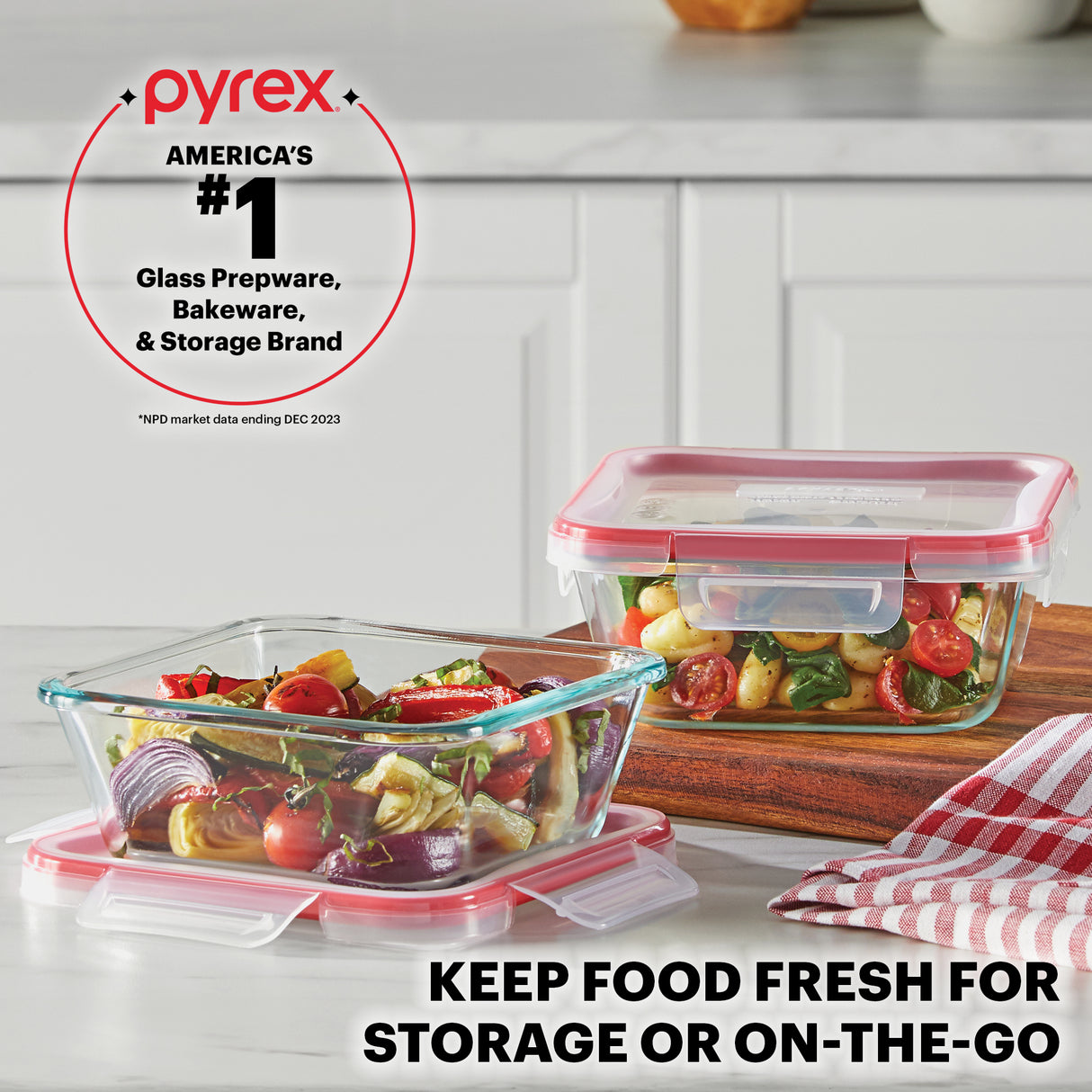 Pyrex food storage containers with vegetables on a kitchen counter, featuring the Pyrex brand logo.