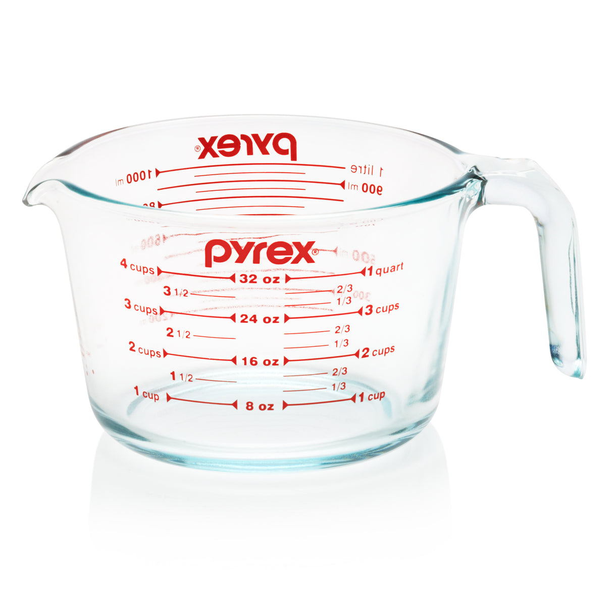 Pyrex measuring cup with red measurement markings on a white background
