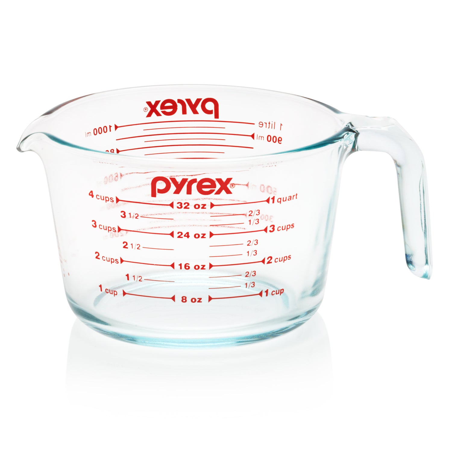 Pyrex measuring cup with red measurement markings on a white background