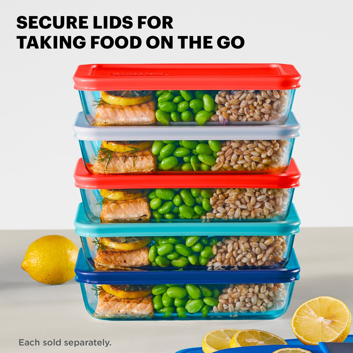 Stack of food storage containers with colorful lids, filled with food, on a light background.