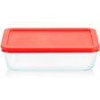 Clear glass food storage container with a red lid on a white background