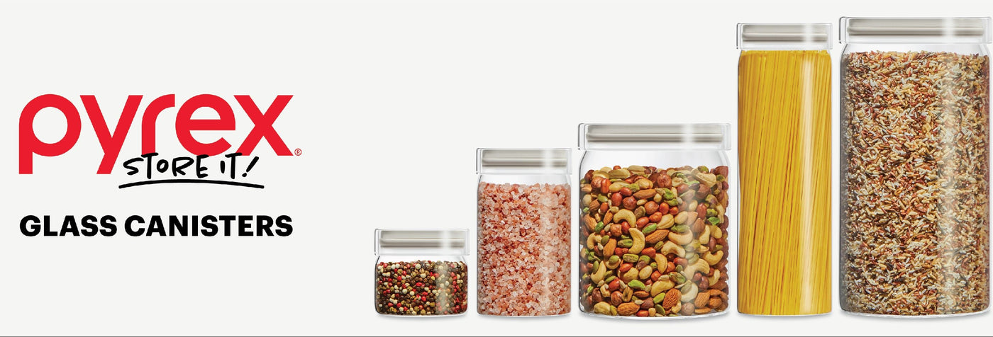 Pyrex glass canisters with food contents on a white background