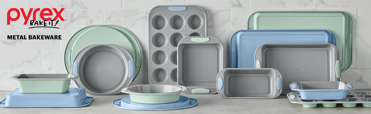 Pyrex metal bakeware set on a light gray background