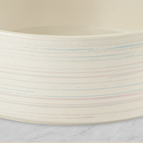 Close-up of a ceramic bowl with a textured surface on a marble countertop