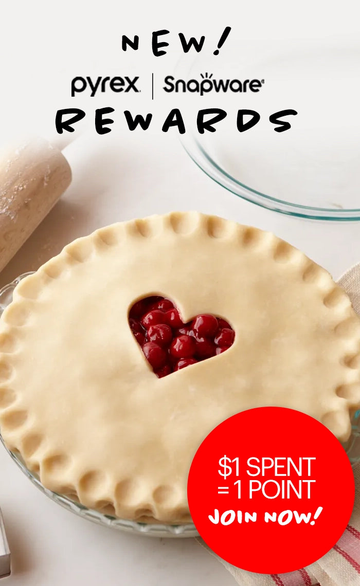 Pyrex and Snapware pie with heart-shaped cutout on a white background