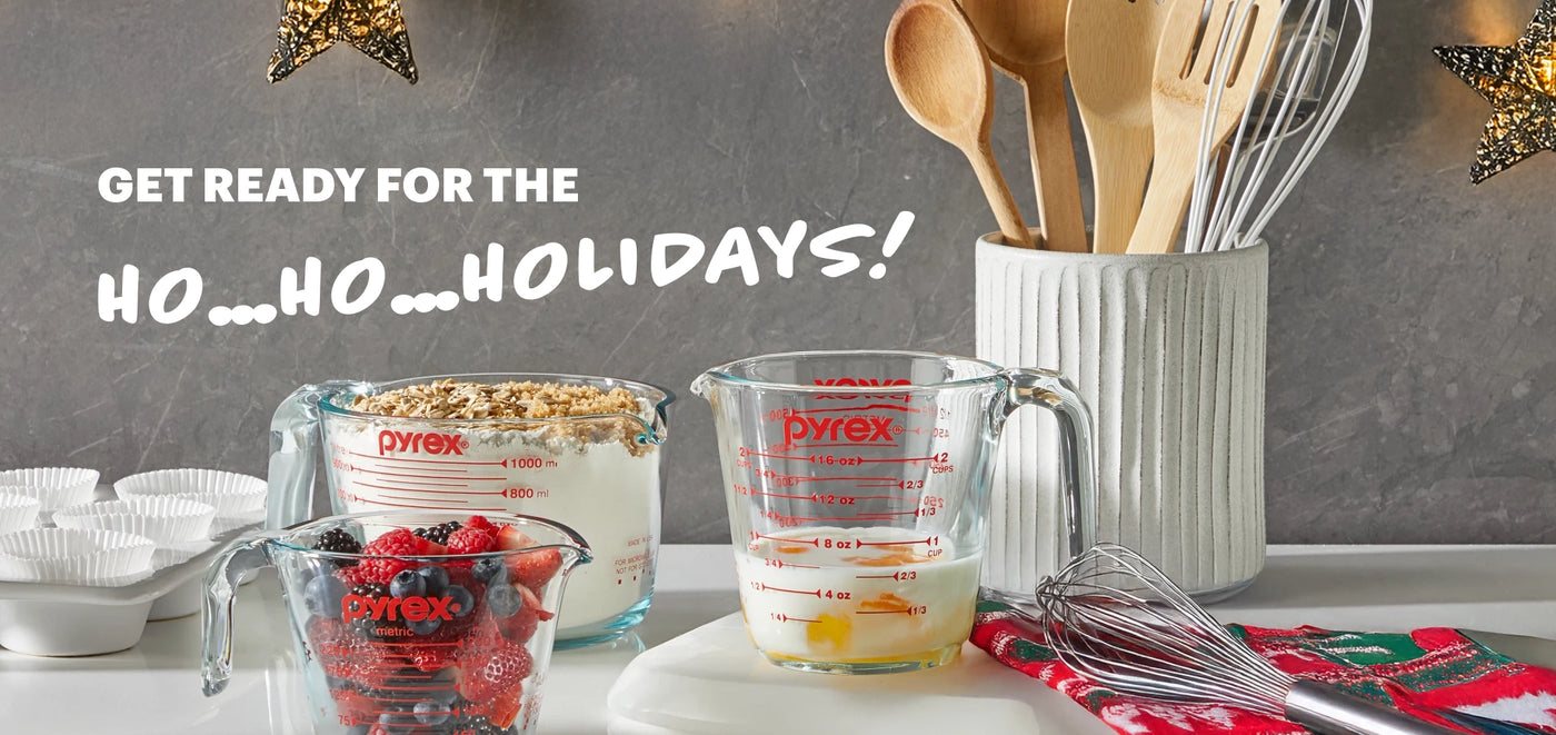 Kitchen utensils and measuring cups with text 'Get ready for the Ho...Ho...Holidays!' on a gray background.