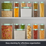 Assorted Snapware® clear plastic canisters with mint green lids arranged in a stackable pantry storage display filled with a variety of dry foods.