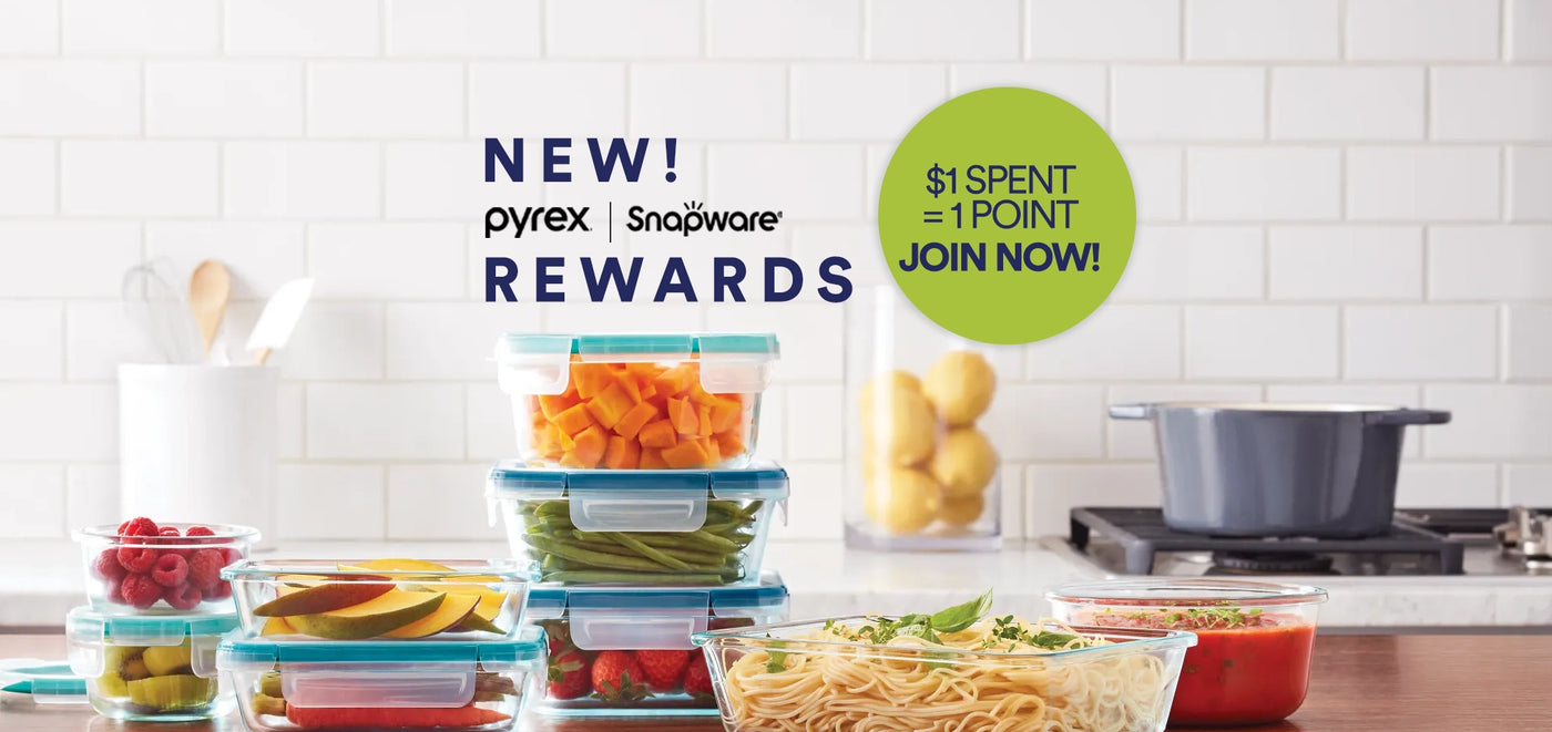 Pyrex storage containers with fruits and vegetables on a kitchen counter, promoting the Pyrex Rewards program.