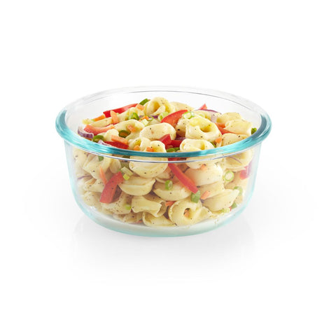 Glass container with pasta salad on a white background