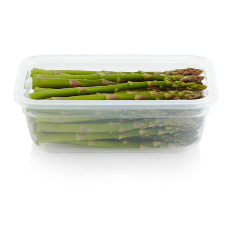 Green asparagus in a clear plastic container on a white background