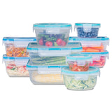 Set of clear food storage containers with blue lids, filled with various foods on a white background.