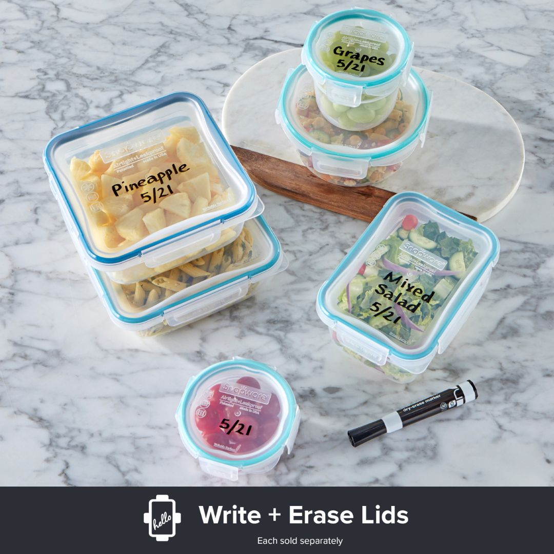 Set of food storage containers with writeable lids on a marble surface