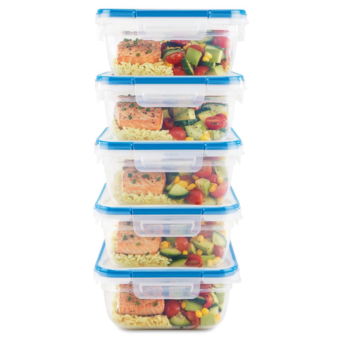 Stack of food storage containers with meals inside on a white background