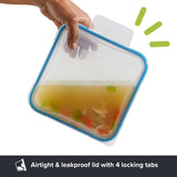 Silicone food container with airtight lid held by a hand, showing a product feature text.