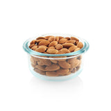 Glass bowl filled with almonds on a white background