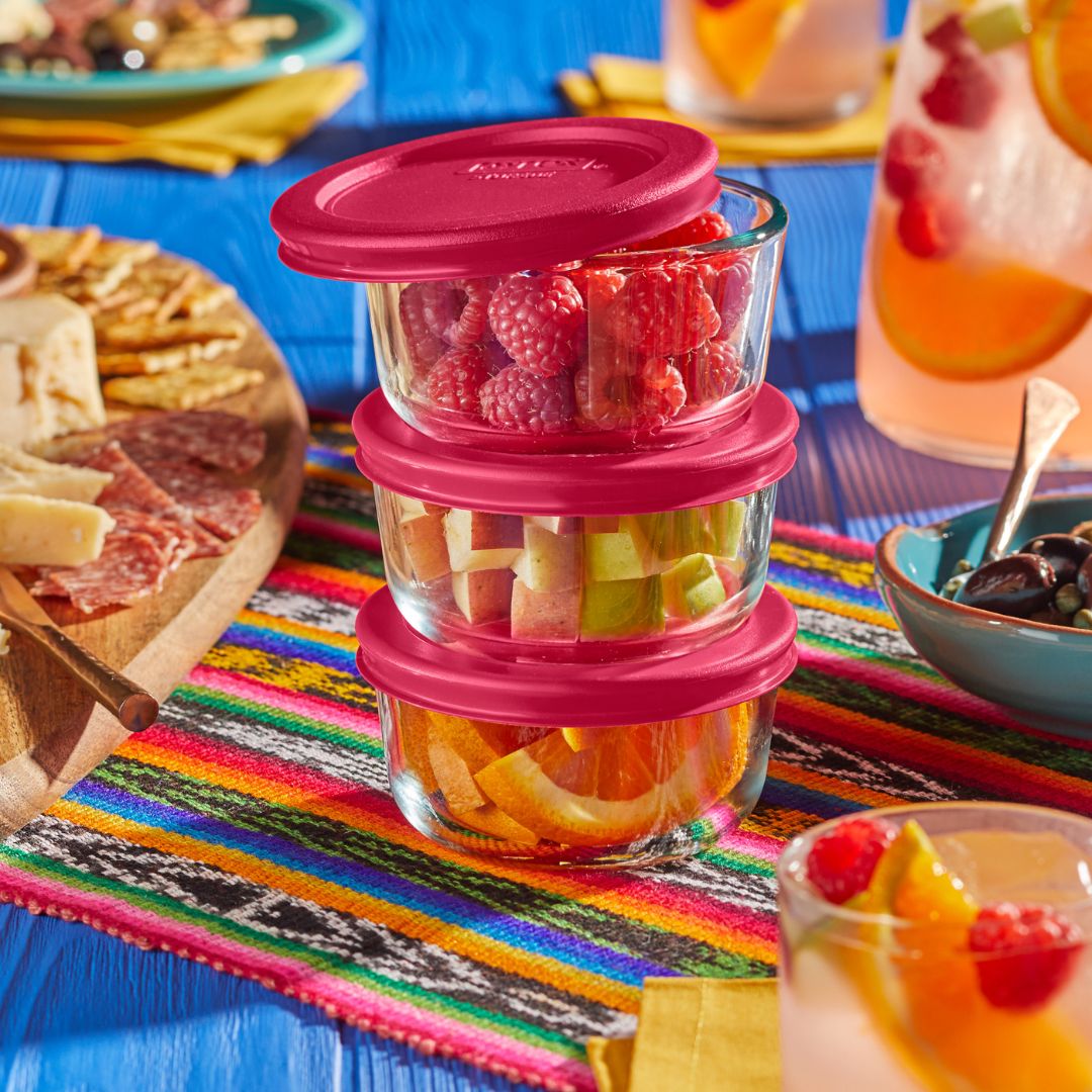 Pyrex glass set, vibrant food on a colorful tablecloth