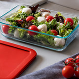 Glass container with salad on a white surface
