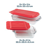 Glass food storage containers with red lids and measurements on a white background