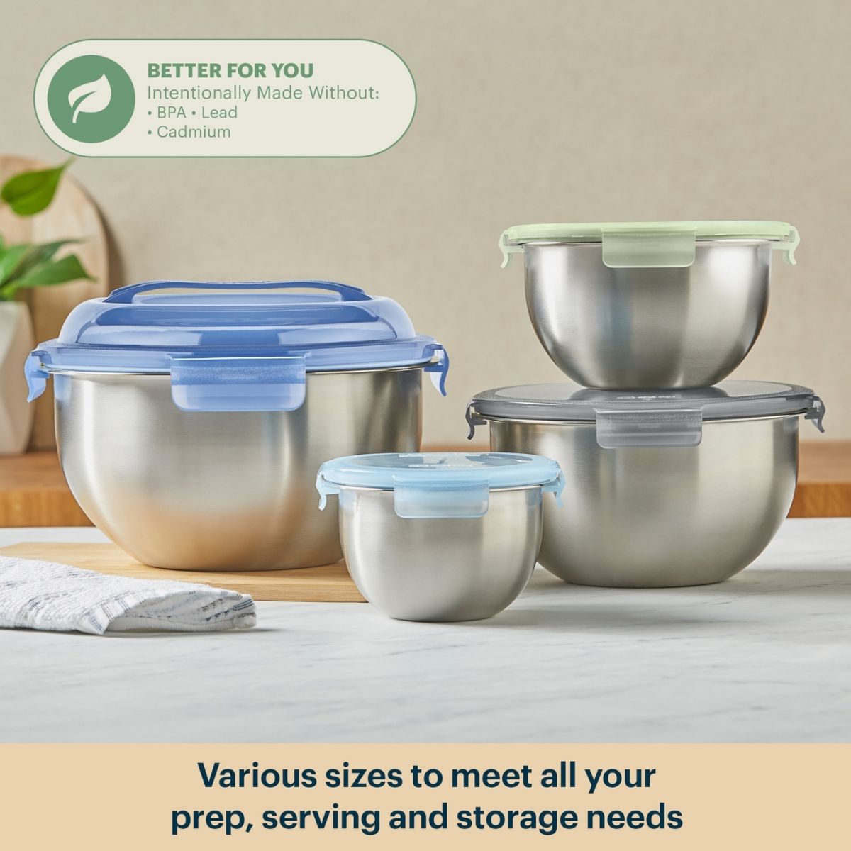 Set of stainless steel food containers with various sizes on a neutral background