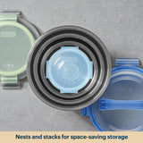 Stackable food containers with lids on a gray surface