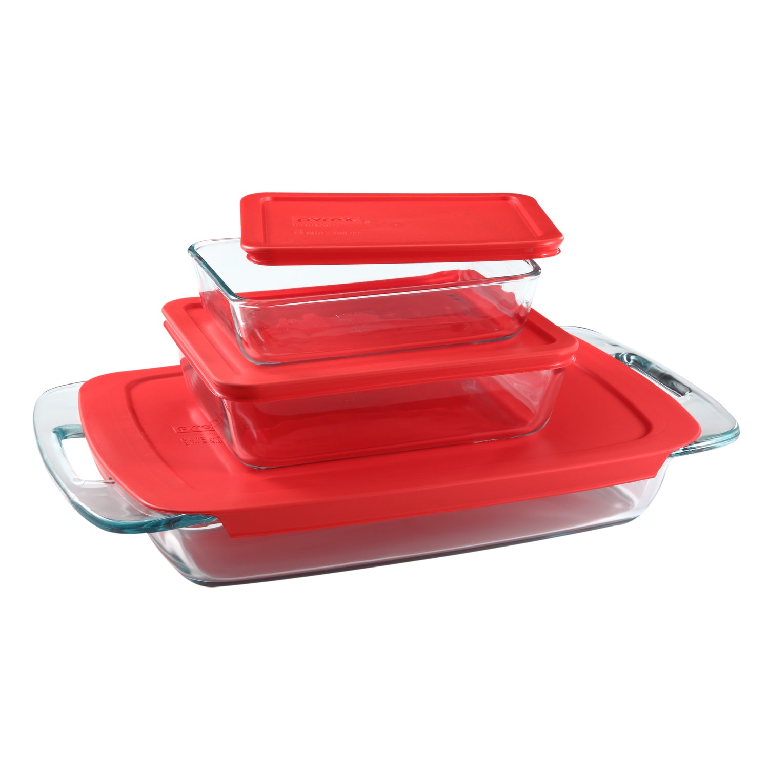 Set of glass baking dishes with red lids on a white background