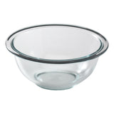 Clear glass mixing bowl on a white background