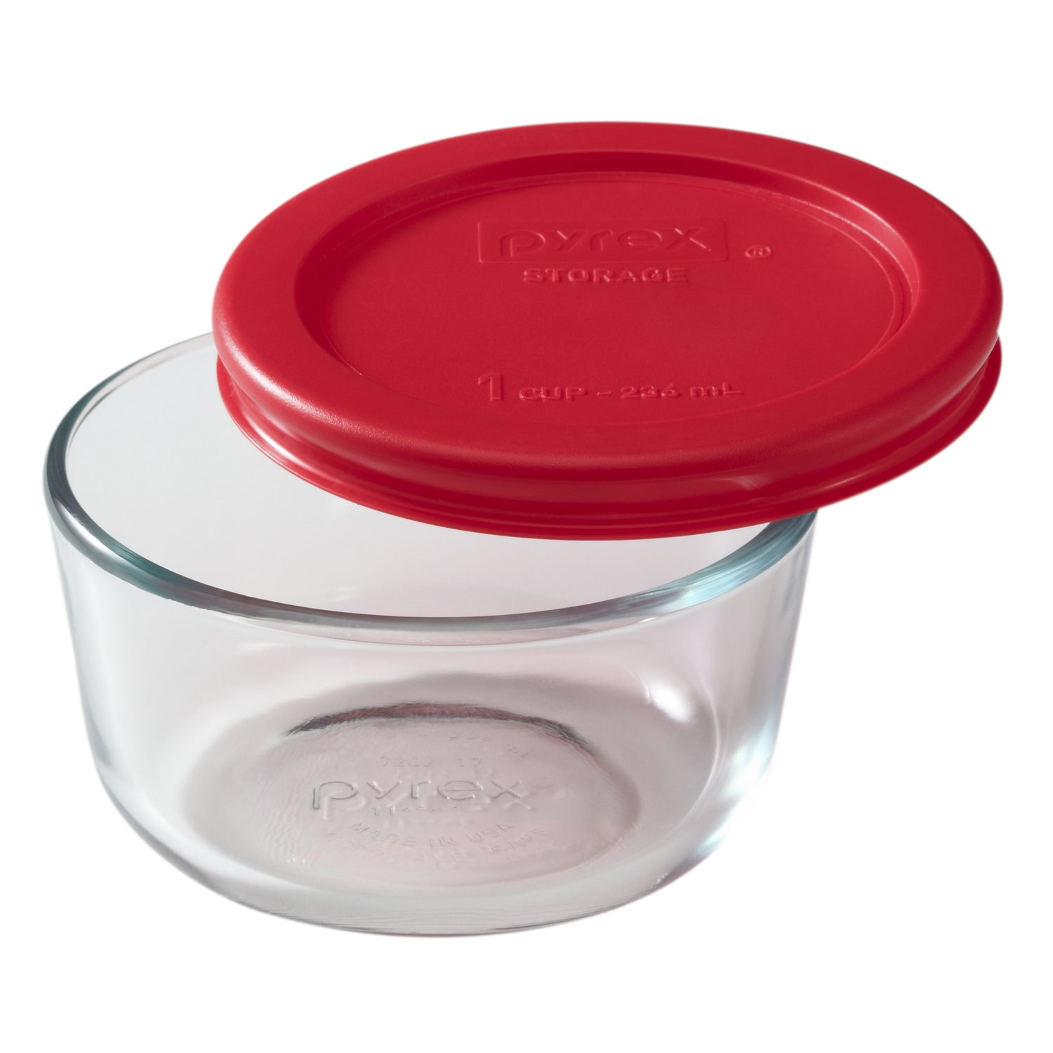 Clear glass storage container with a red lid on a white background