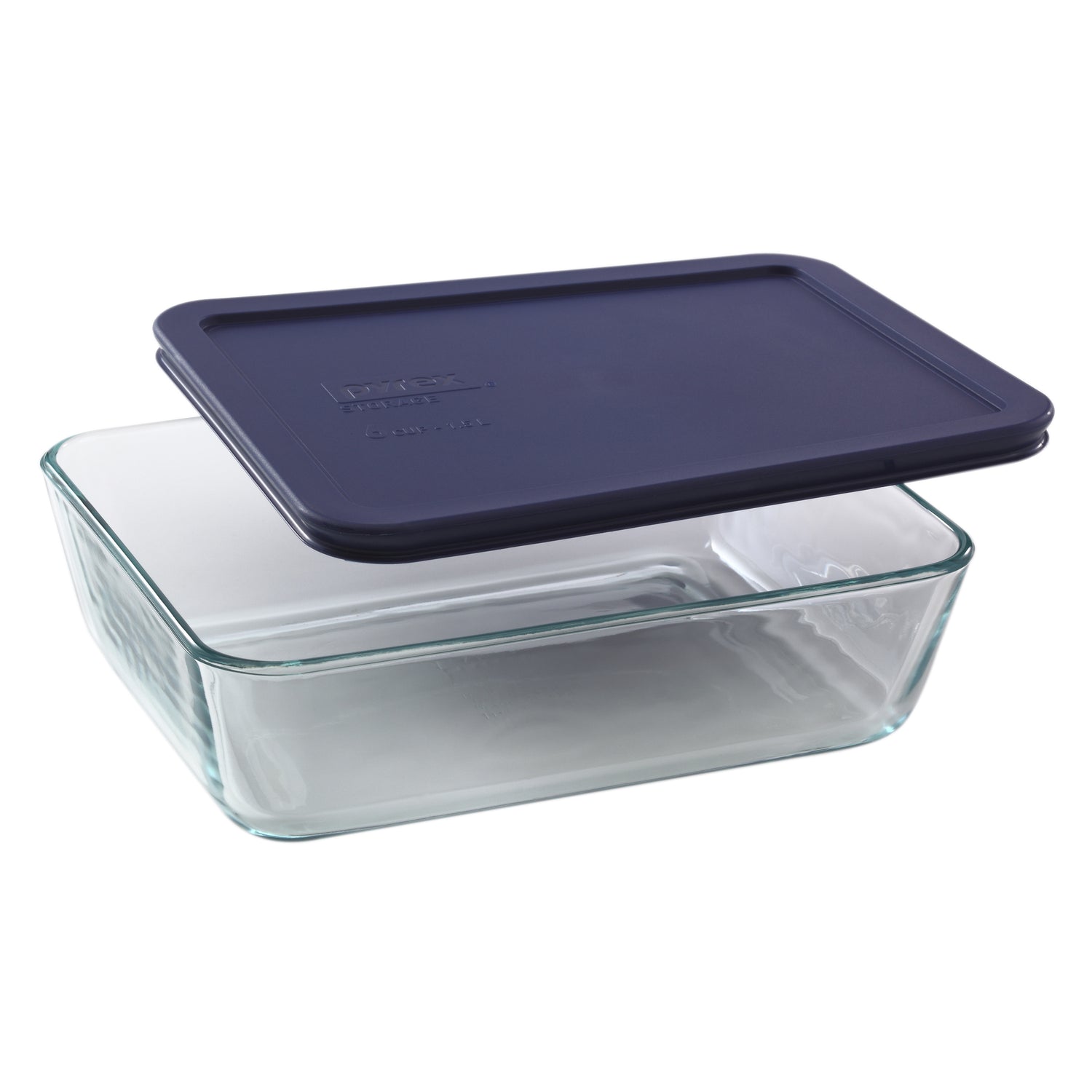 Glass food storage container with a navy blue lid on a white background